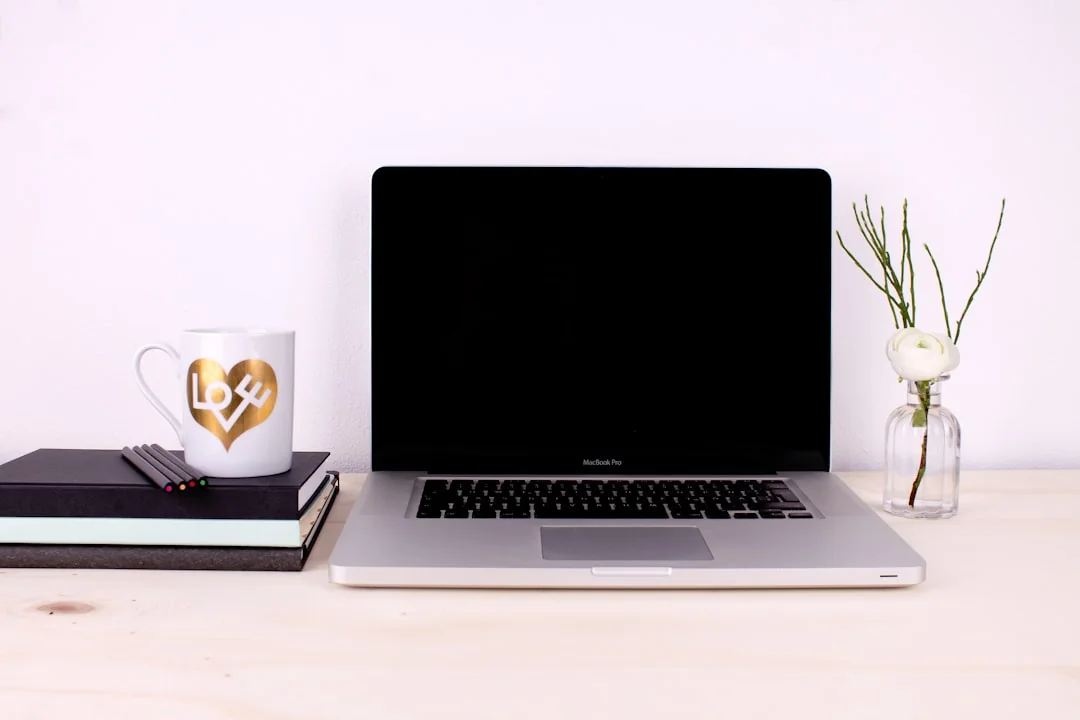 A modern workspace featuring dual computer monitors displaying web design projects, emphasizing technology and productivity.